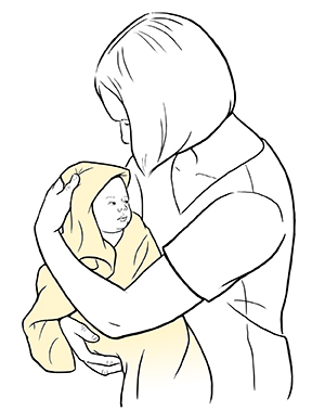 Woman holding baby wrapped in hooded towel.