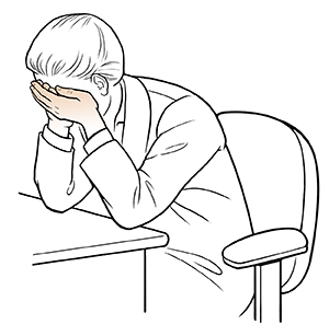 Woman sitting at desk doing eye cup exercise.